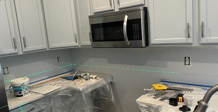Before: bare wall with laser level line
