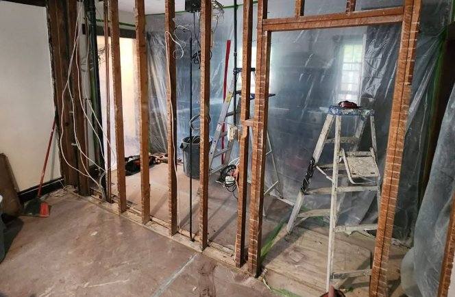 Before: wall opened to the studs during demo